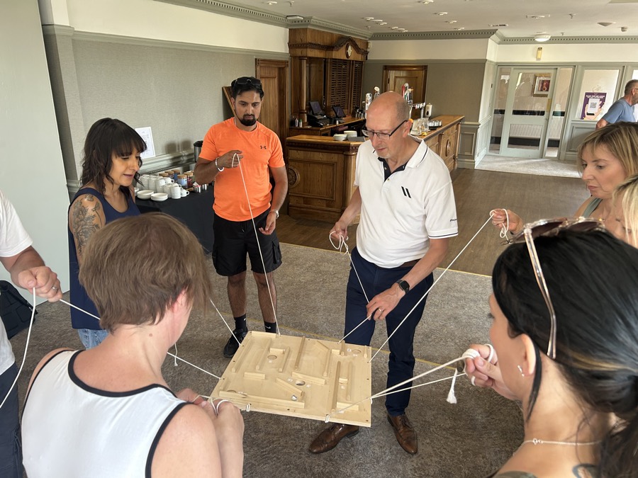 A mixed group working on a build together, everyone with a job